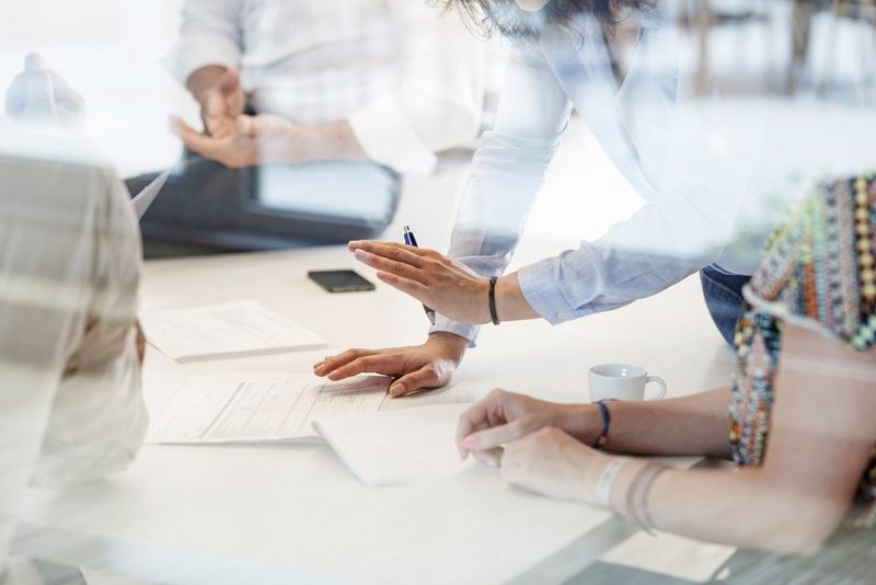 Business meeting in conference room behind glass wall